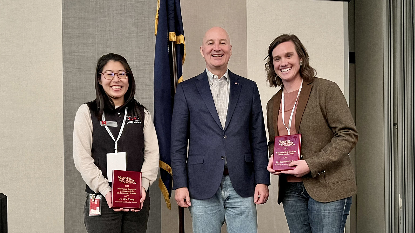 Dr. Yijie Xiong, Governor Pete Ricketts, and Dr. Kacie McCarthy