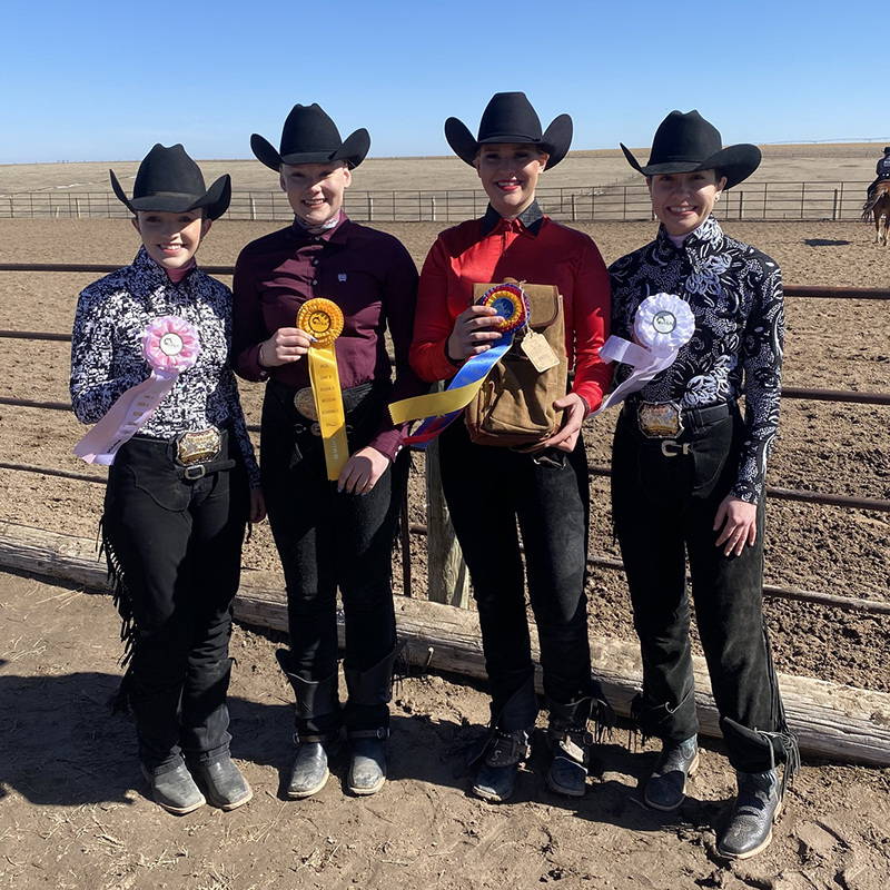 Equestrian team members with awards following competition
