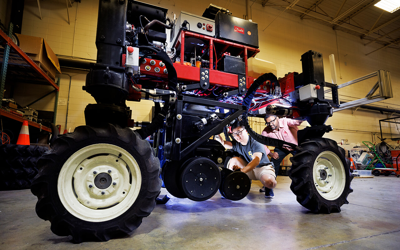 researchers working on robotic farm equipment