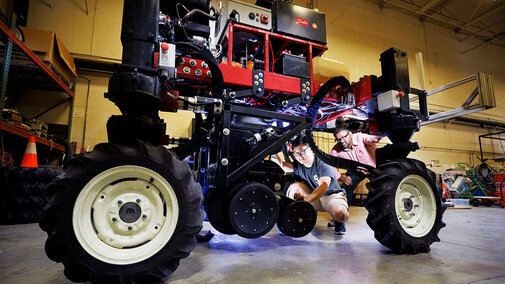researchers working on robotic farm equipment
