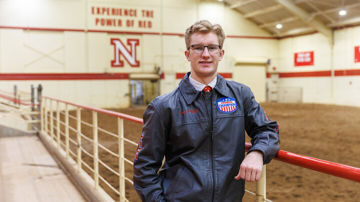 Greg Treffer, a Junior Animal Science and Pre-Veterinary Medicine major, and a member of the UNL Horse Judging Team poses for a portrait in the Rodeo and Equine Sports Complex.