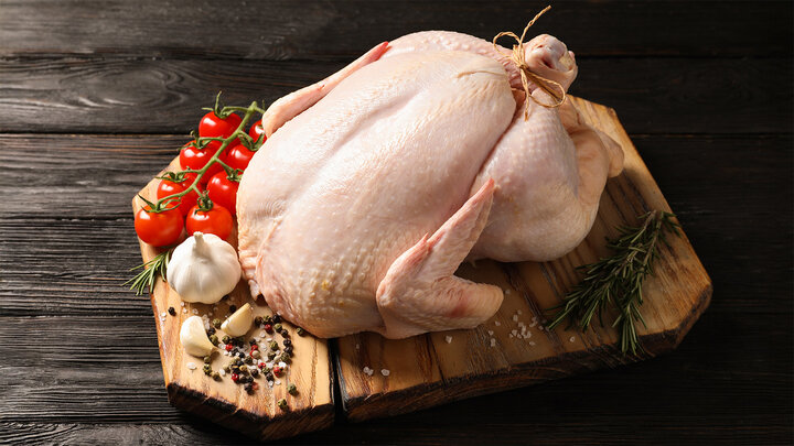 uncooked turkey on a wooden serving board