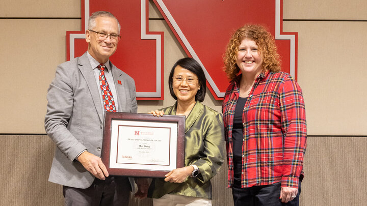 Mai Dang (center) is presented her award by Dr. Richard Bischoff (left) and Carrie Adams (right)