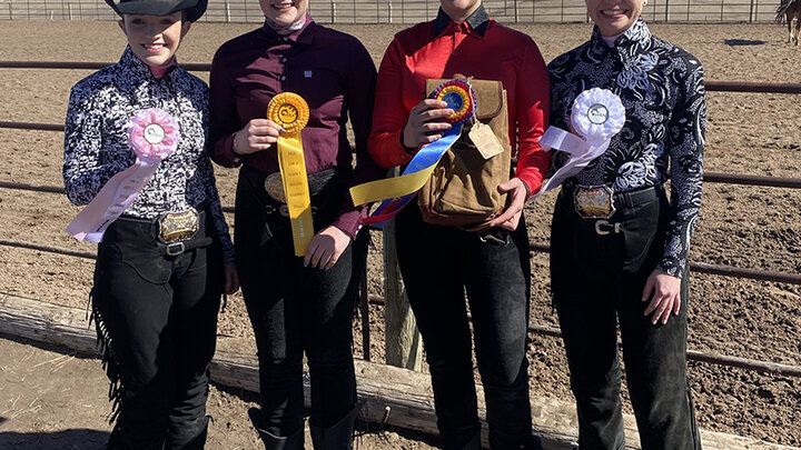 Equestrian team members with awards following competition