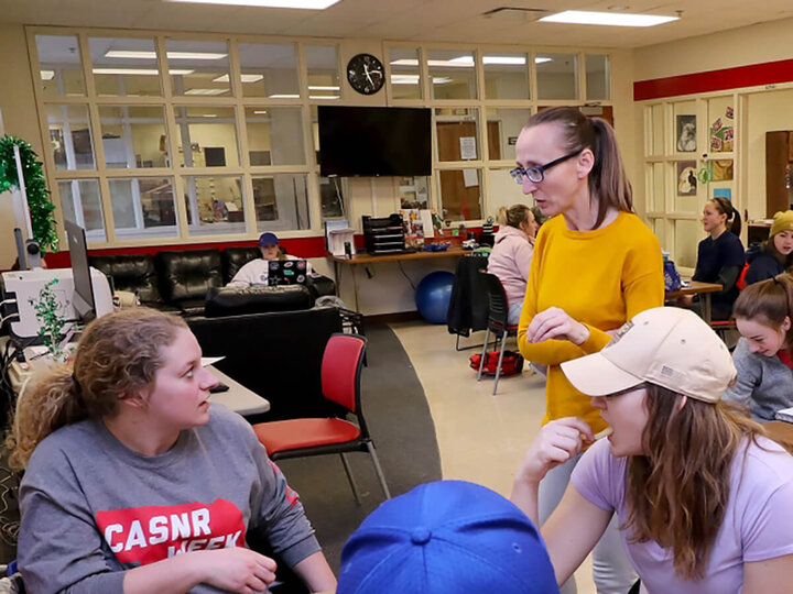 Students getting some questions answered by a faculty member