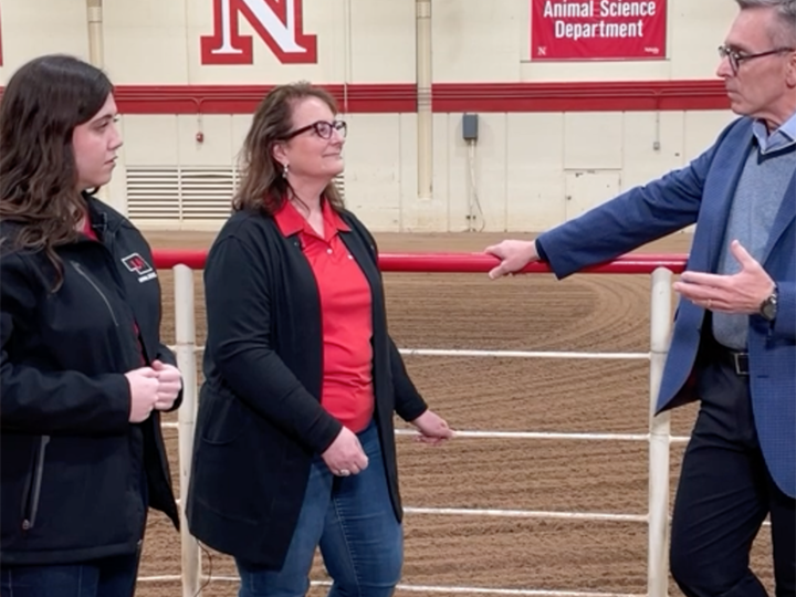 Dr. Ronnie Green speaking with Dr. Andrea Cupp and a student