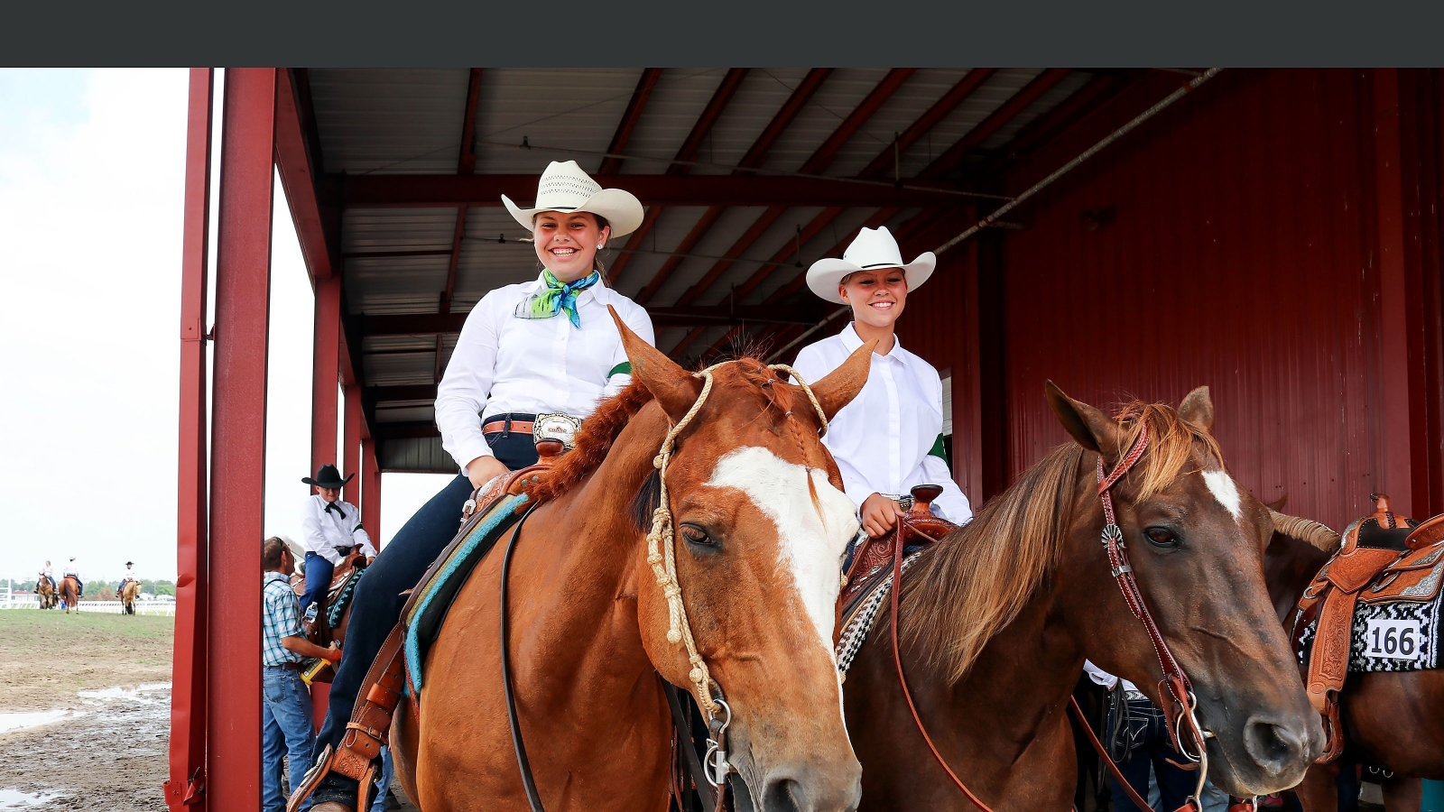 two 4-h riders on a horse pose for picture