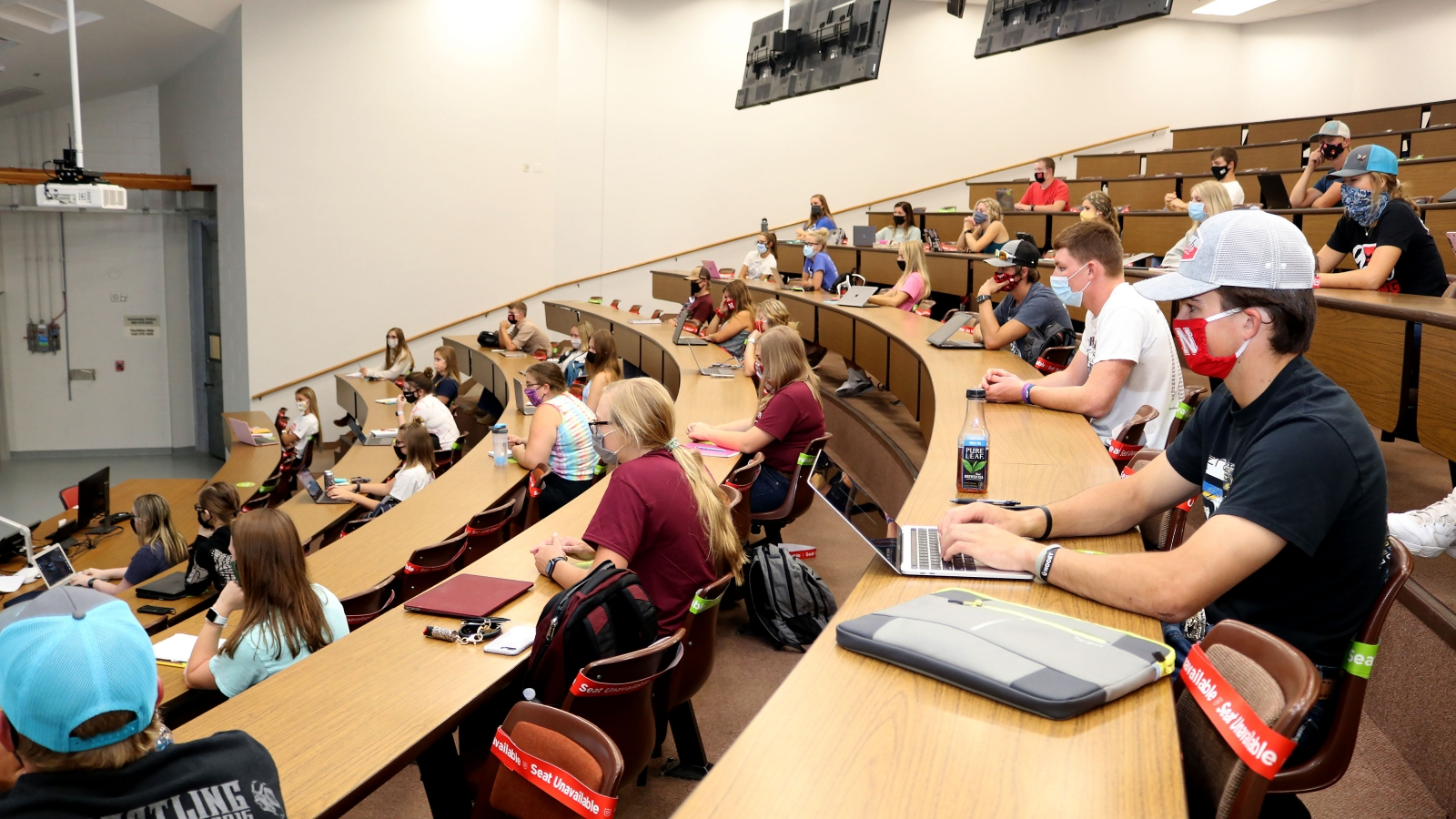 side view of a group of student sitting in a large lecture room.